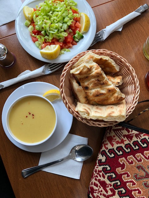 Enjoying lunch in Istanbul with soup, bread and salad, accompanied by sumak kilim bag in pocketbook style. 