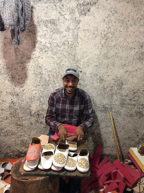 Cobbler in Marrakech working on shoes.