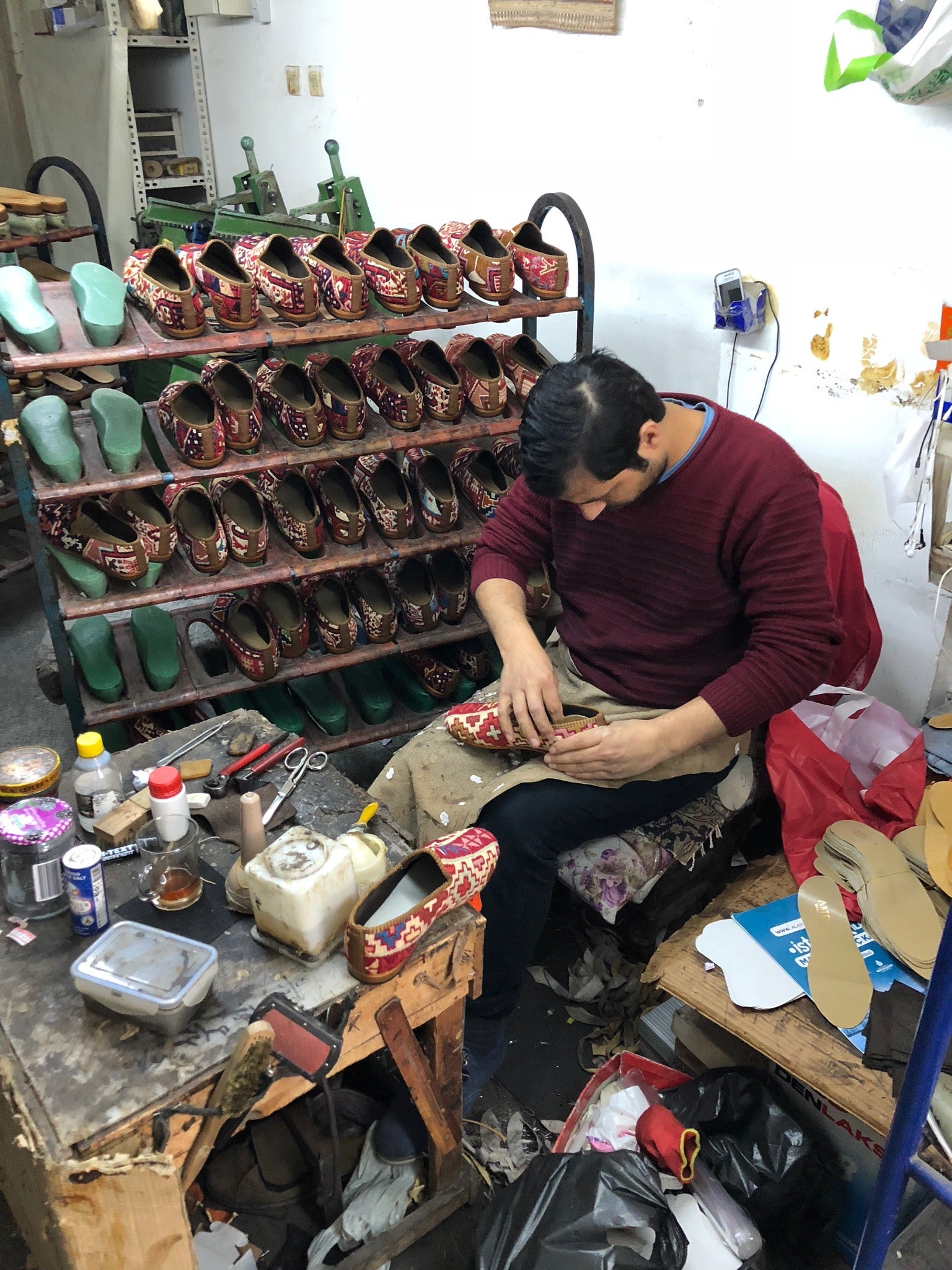 cobbler in workshop with kilim shoes