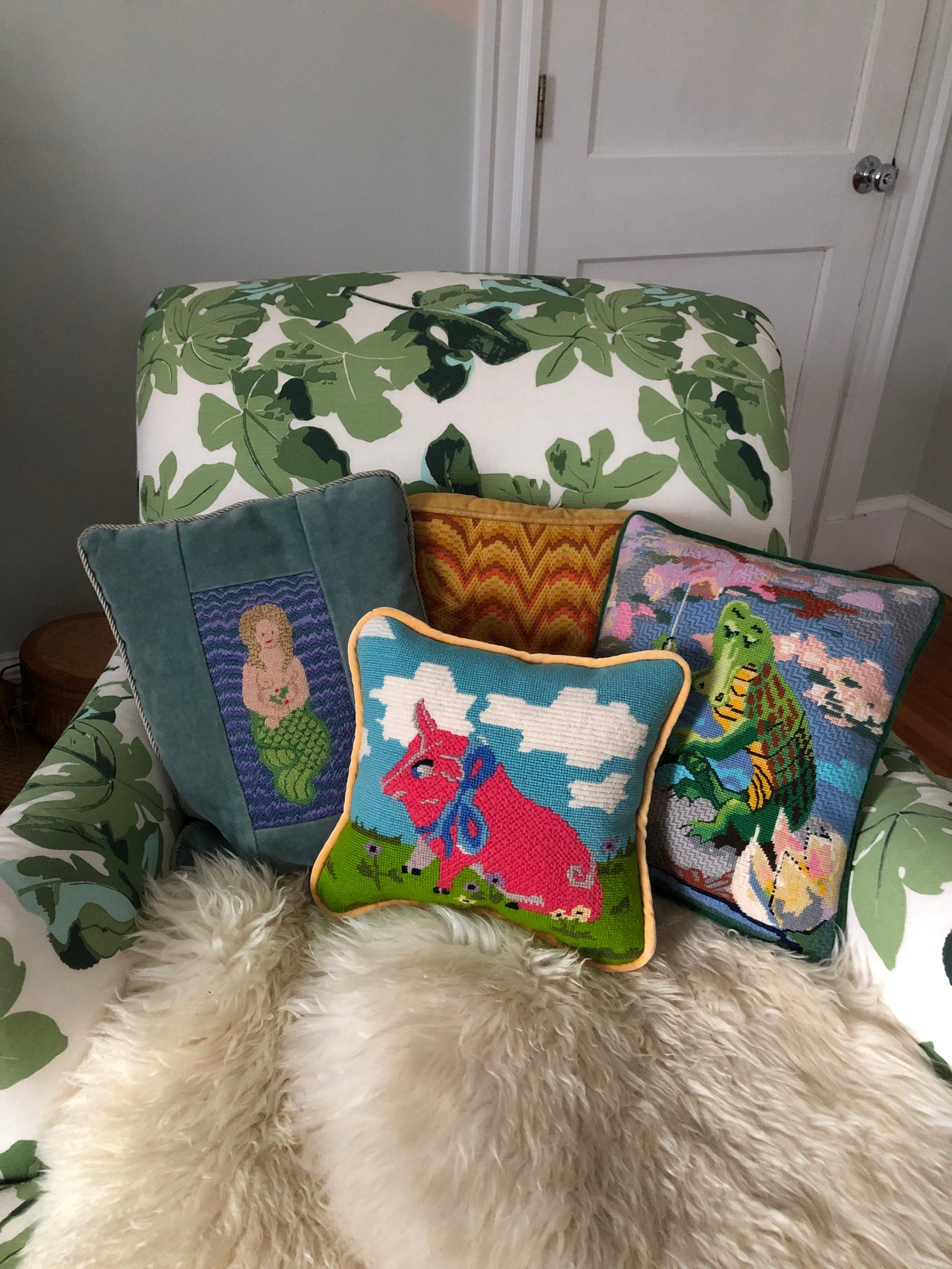 needlepoint pillows on chair