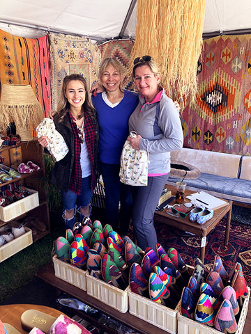 brimfield antique market customers with their new womens velvet slides and womens kilim loafers surrounded by kilim carpets and mens kilim loafers.
