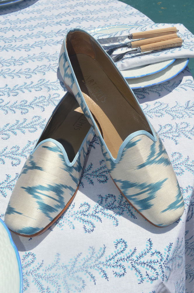 Silk loafers match the handmade table clothe they are resting on. 