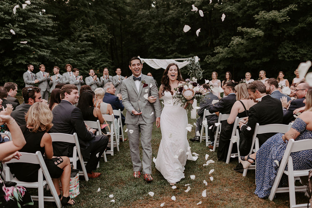 bride and groom walking down the isle in Artemis Shoes