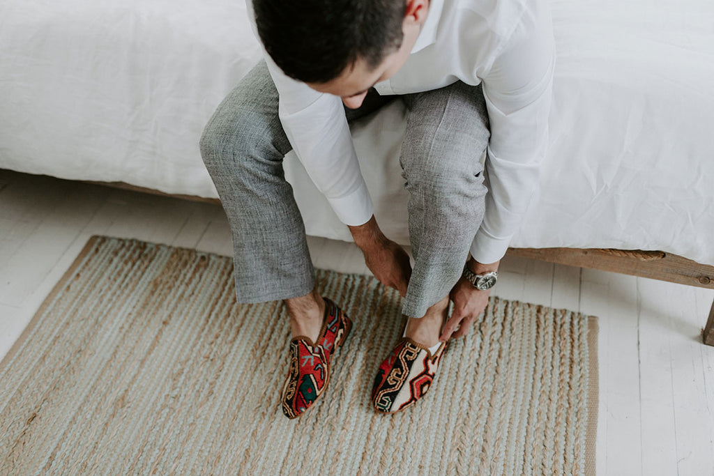 Groom putting on Artemis shoes for this big day