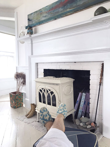 blue and white velvet slippers in front of white fireplace in provincetown, cape cod home.