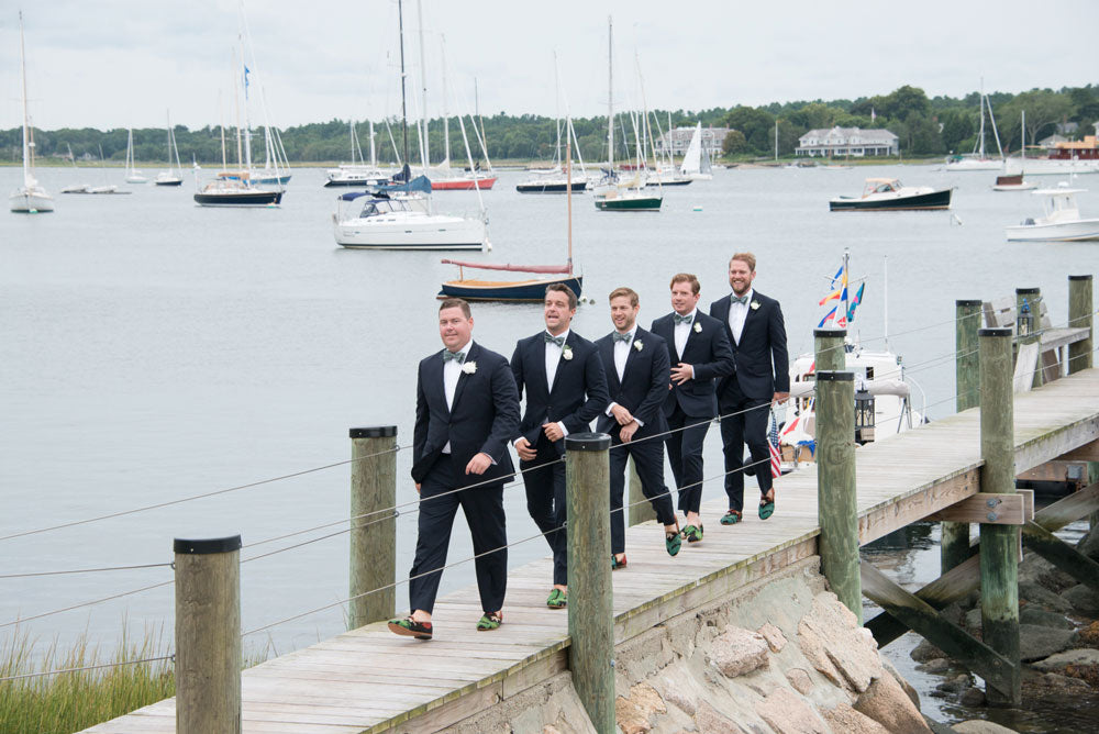 Nadler-corkery groomsmen wearing our kilim smoking shoes walking on a dock.