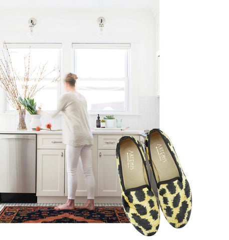 Sarah Scales in white kitchen on kilim carpet paired with leopard print McNeill velvet smoking shoes.