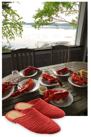 nantucket red raffia babouche in front of scenic maine lobster dinner.