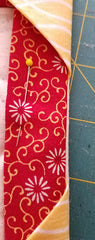 close-up image showing some of the quilt top showing on the backside