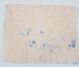 Image of light colored fabric with spots of blue that bled while in the washer; from Colorado Creations Quilting