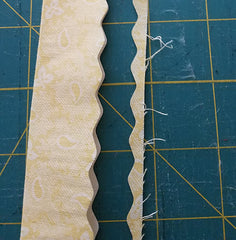 image shows the binding strip with a scalloped edge