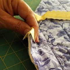 image shows the quilt "sandwiched" between the binding strip