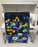 Image of fabric being loaded into a Mangle ironing machine by Colorado Creations Quilting