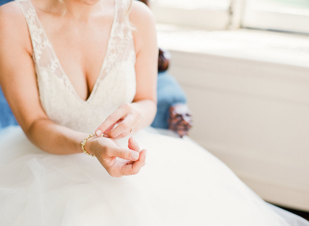 bride getting dressed - tips about trying wedding dresses on at home from The Garter Girl