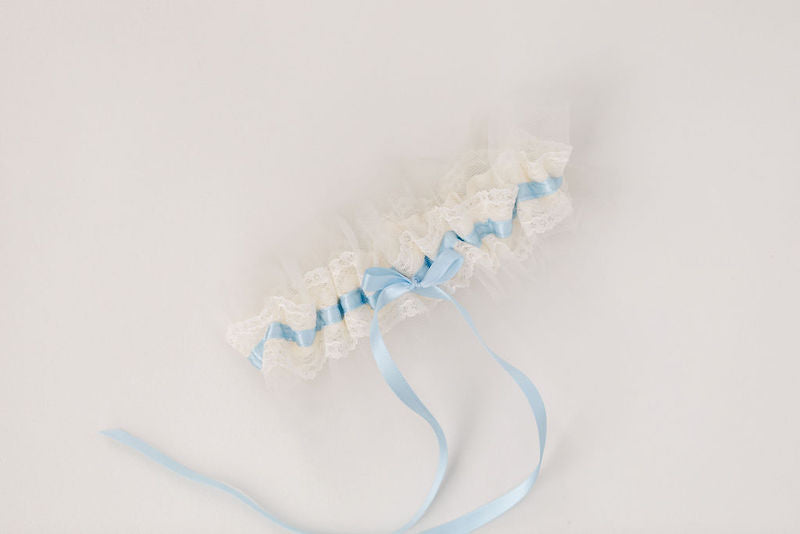 custom wedding garter with ivory tulle and lace with light blue satin and personalized with a pink heart embroidered