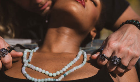 Man and woman wearing jade necklaces and men's rings