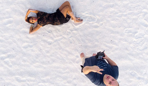 Drone img DJI drone male and female on white sand beach