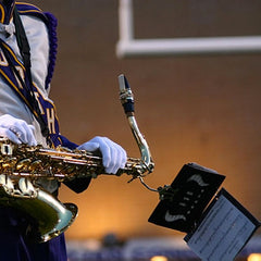 sax player with marching band uniform and lyre holder