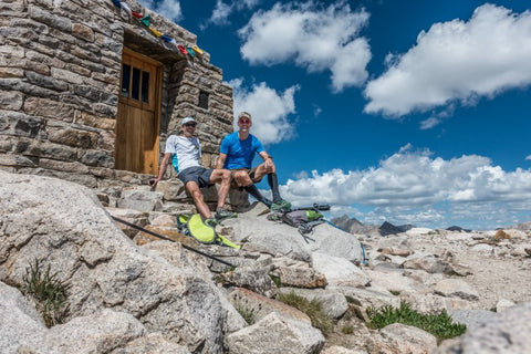 stone house with two hikers