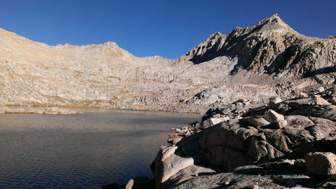 Mountain scape with lake trees and clouds