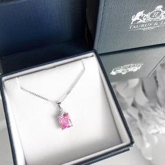 Justice sterling silver pendant with emerald cut pink cubic zirconia.