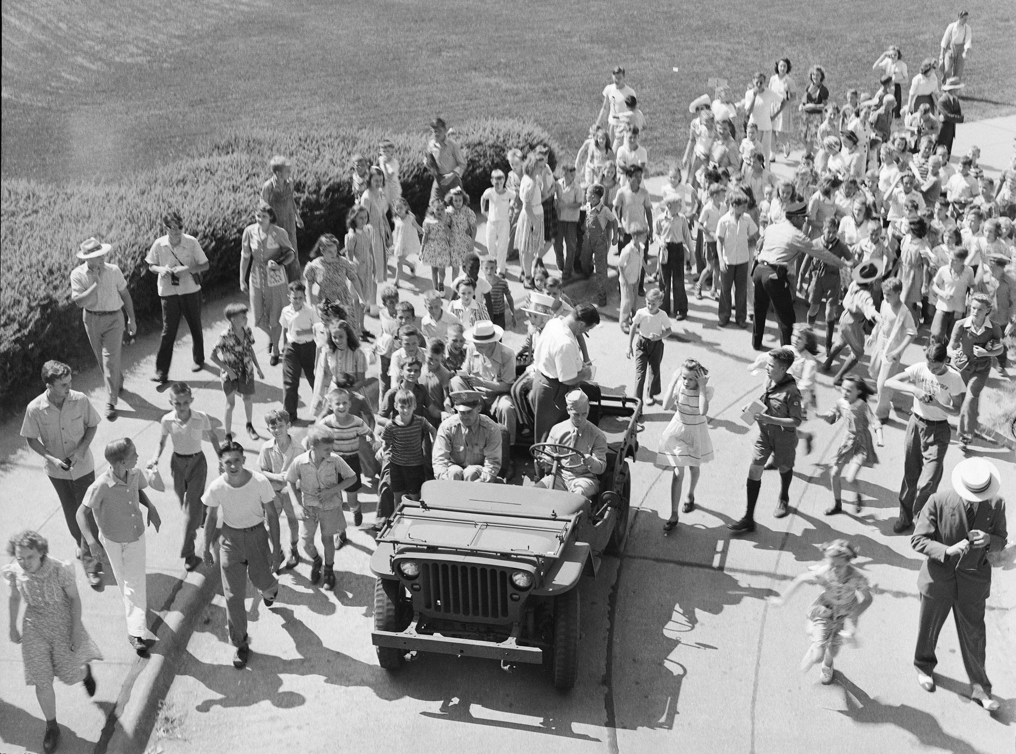 Bud Abbott and Lou Costello signing autographs for children from a jeep in front of the State Capitol Building, July 31, 1942. -- Courtesy Nebraska State Historical Society / #RG2183.PH001942-000731-2