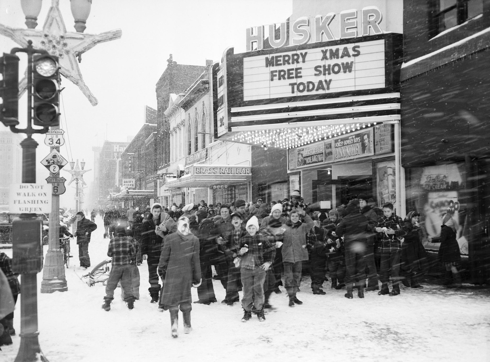 A group of children in front of the Husker Theater, located at 1444 O Street, on Christmas Eve, 1948. -- NEBRASKA STATE HISTORICAL SOCIETY / #RG2183.PH001948-001224