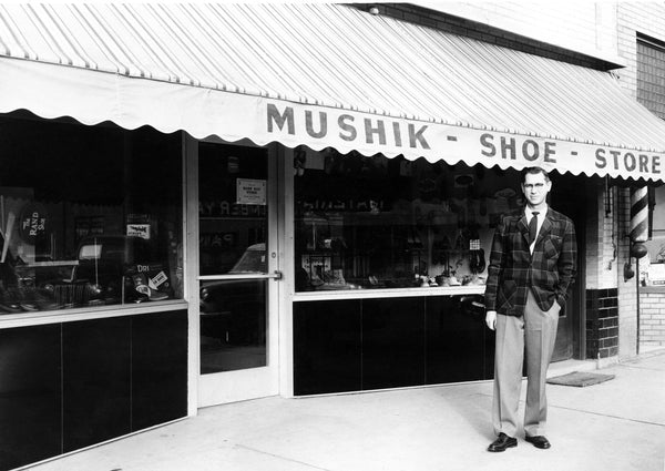John Mushik III, in front of his family–owned shoe store, 116 W. Main, Mandan, 1957. John was the third generation of Mushiks who owned and operated the store for 70 years.  -- Courtesy Becky Mushik Roesler