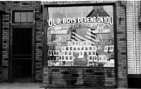 A patriotic display in the window at Mushik Shoe Store, 112 W. Main St., Mandan, 1942. Photos of Mandan and surrounding area men who were serving in the armed forces in World War II were displayed. The Mushiks had three sons in that window display. -- Courtesy Becky Mushik Roesler