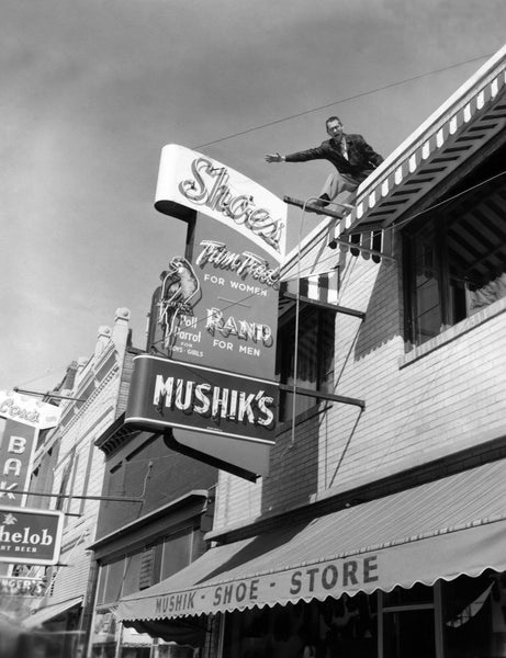 John Mushik III, on the roof of his store advertising “Mad” Market Days, 116 W. Main, Mandan, 1957. During “Mad” Market Days, stores would have sidewalk sales and the employees wore crazy costumes. -- Courtesy Becky Mushik Roesler