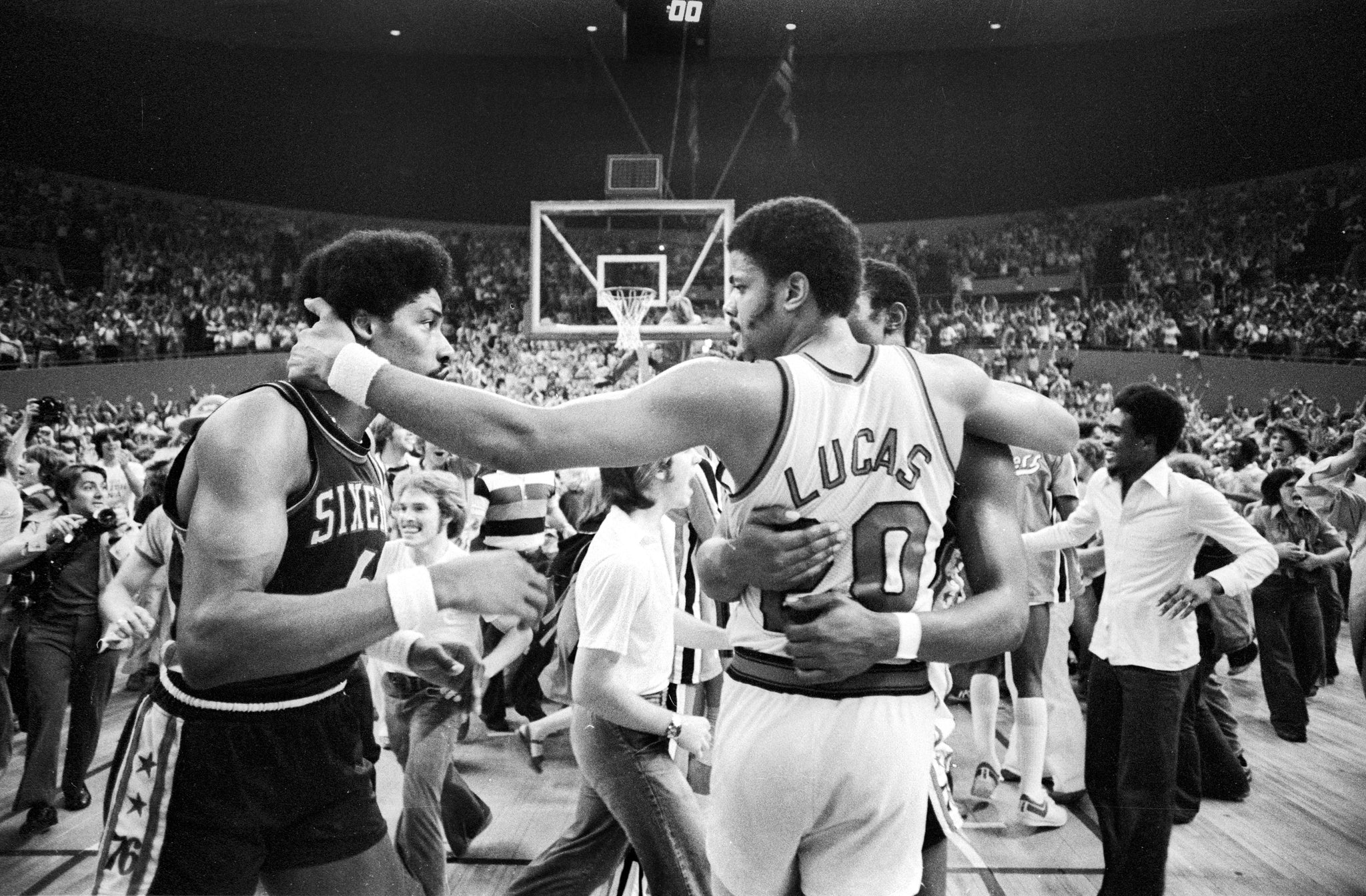 Blazers forward Maurice Lucas (20) shares a moment with 76ers star Julius Erving (6) after Game 6 of the 1977 NBA Finals. -- MICHAEL LLOYD / THE OREGONIAN/OREGONLIVE