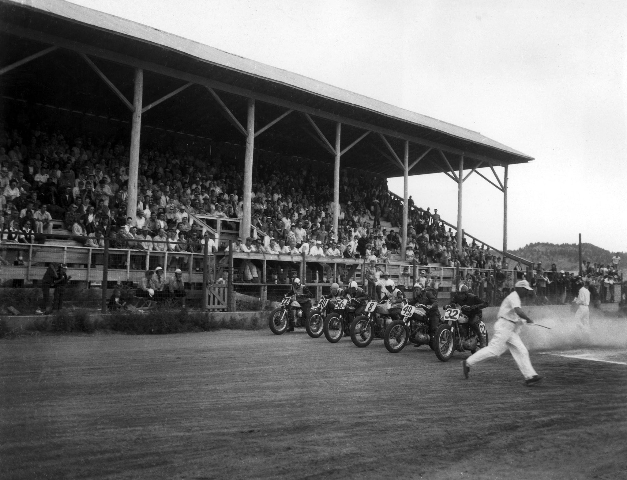 Motorcycle racers speed off from the starting line during an early year of the Black Hills Motorcycle Classic in Sturgis.