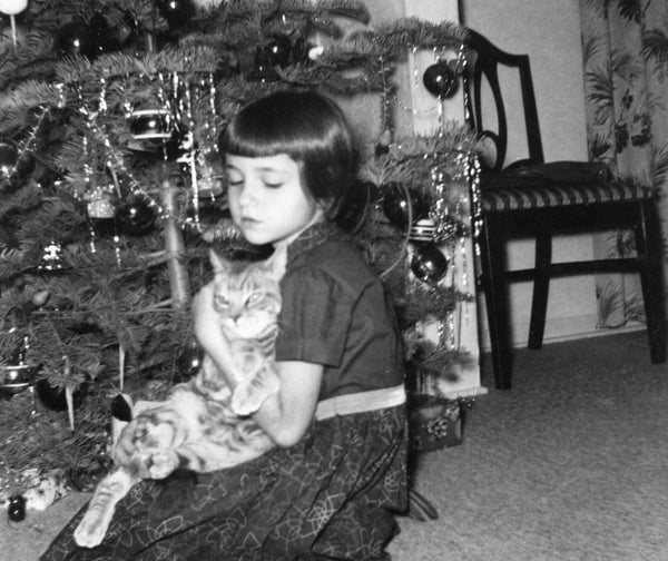 Paula Savino and rescued kitten “Fuzzy” at their home in Fresno, Christmas 1956. -- PAULA SAVINO