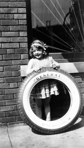 Joyce Anderson with an Anderson Tire outside her dad’s store on State Street, 1931. She was a local singing star and often sang for money outside of Ma Bennet’s next door. -- Courtesy Brooksy Beilke-Skoug