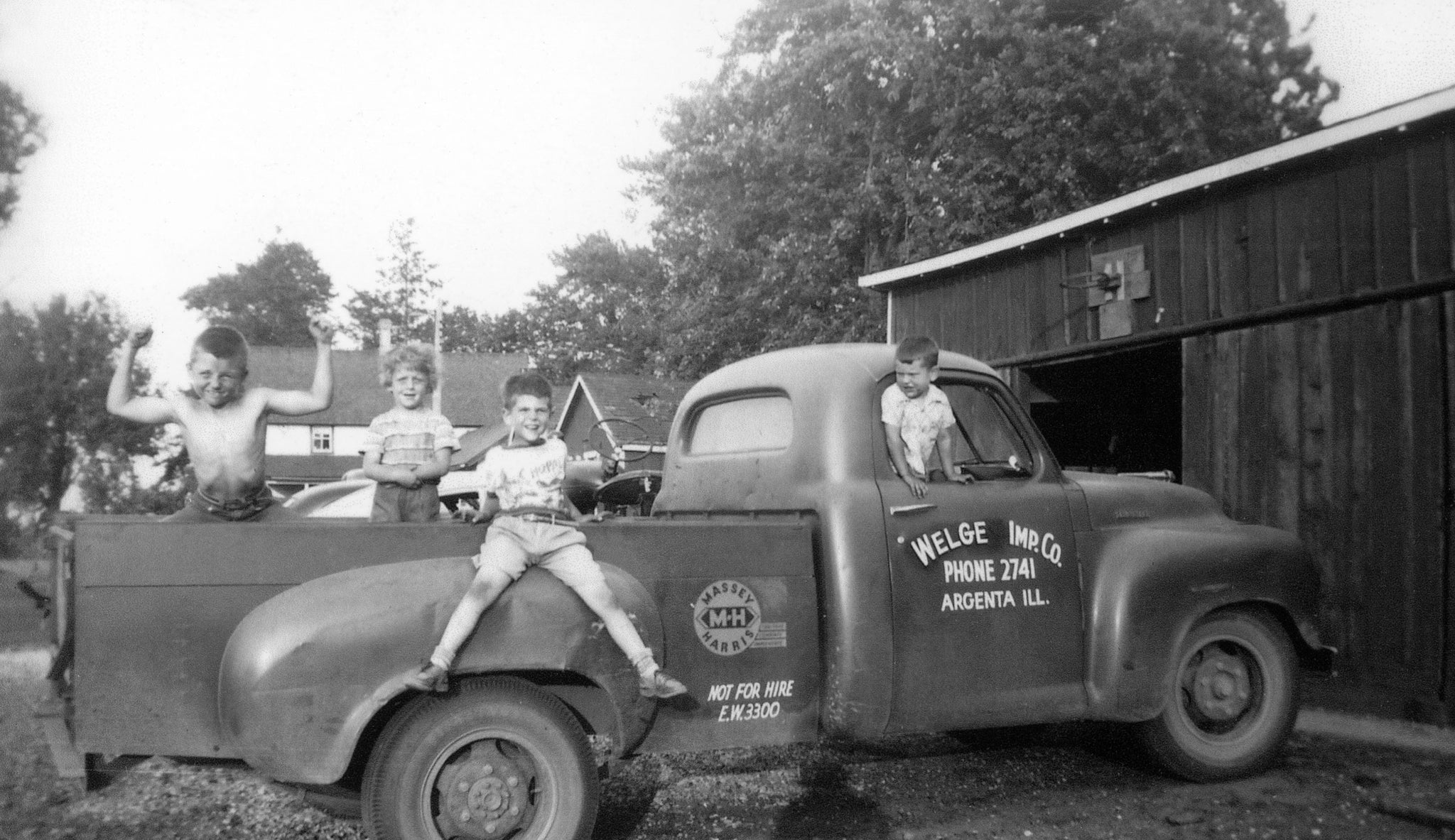 Children playing on the Welge Implement Co. truck in Argenta, circa 1959. -- Courtesy Curt Jackson