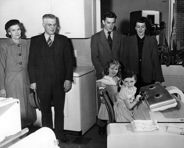 Five–year-old Sally Ann Vest (Kates) demonstrating how to use a Baulos ironer, 1948. Next to her is Shiela Jo Deneen (Deal). -- Courtesy Sally Ann Kates