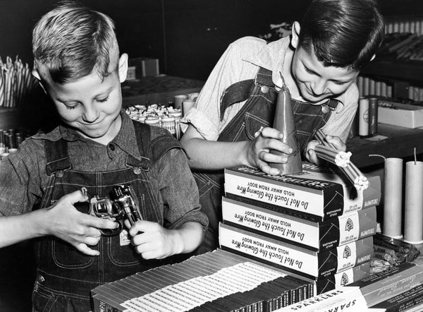 Jimmy and Danny Nichols, ages 6 and 10, handling fireworks and toy guns in 1939. -- Courtesy Herald & Review
