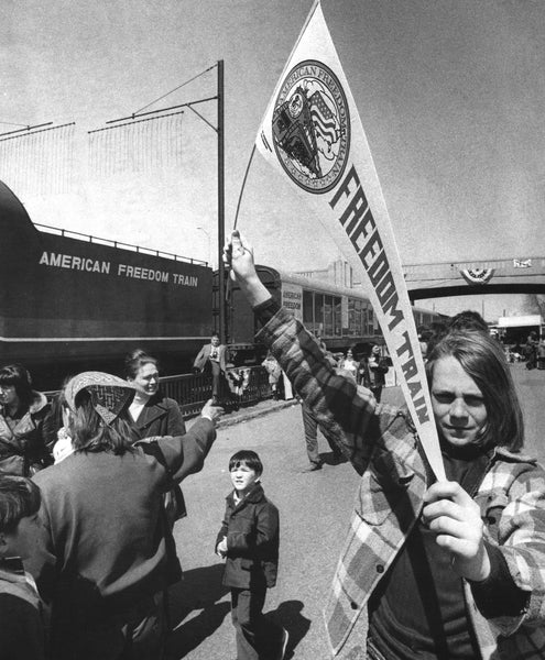 A young Queen City resident proudly displays her American Freedom Train banner on April 15, 1975.  -- Photo by Alan Jahn. Union Leader Archives
