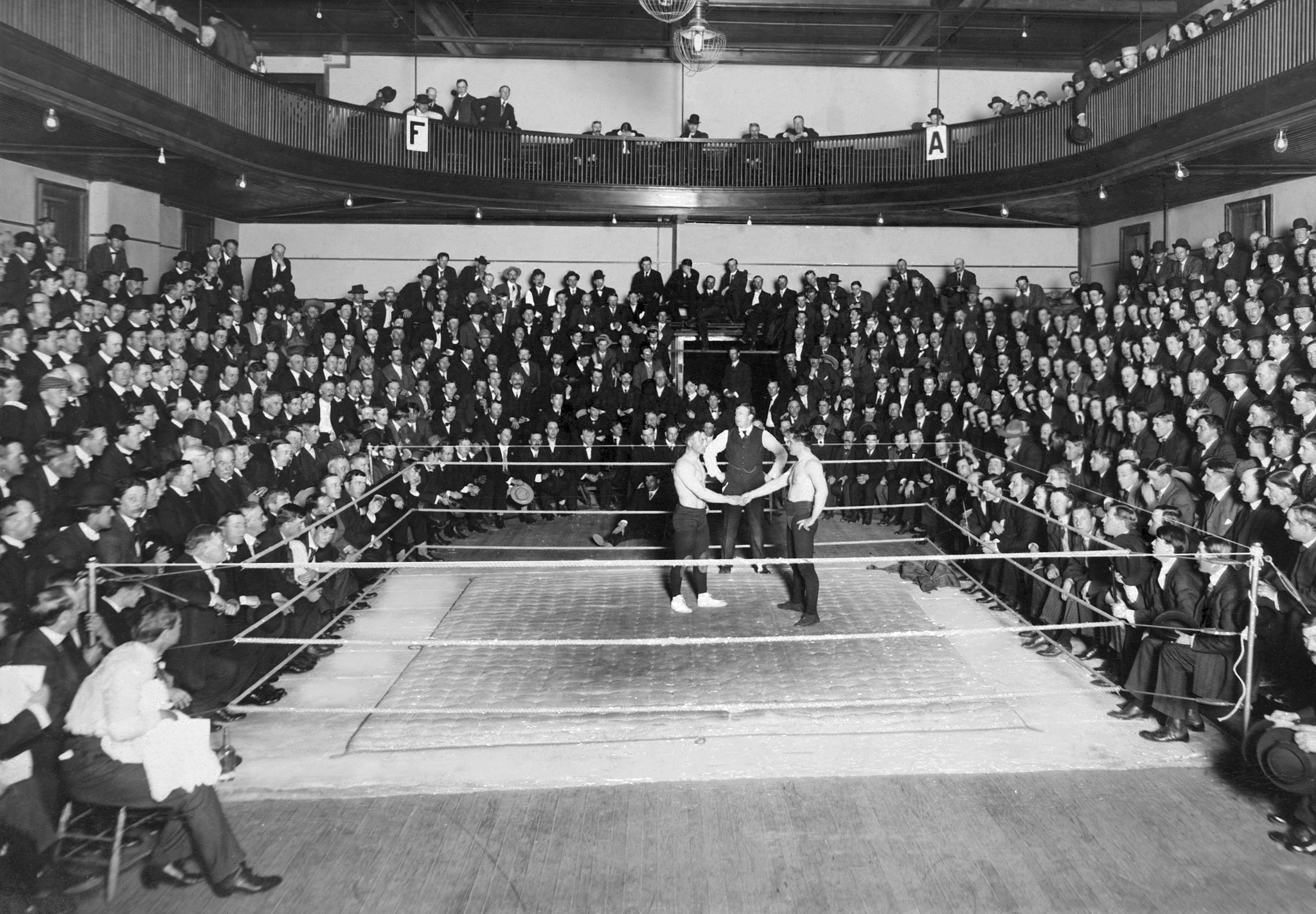 Fred Beell, on left, wrestling at the armory on Second Street, circa 1913. Beell retired from wrestling undefeated in 1919, holding the light, medium and heavyweight crowns. -- Courtesy North Wood County Historical Society / #U108.31
