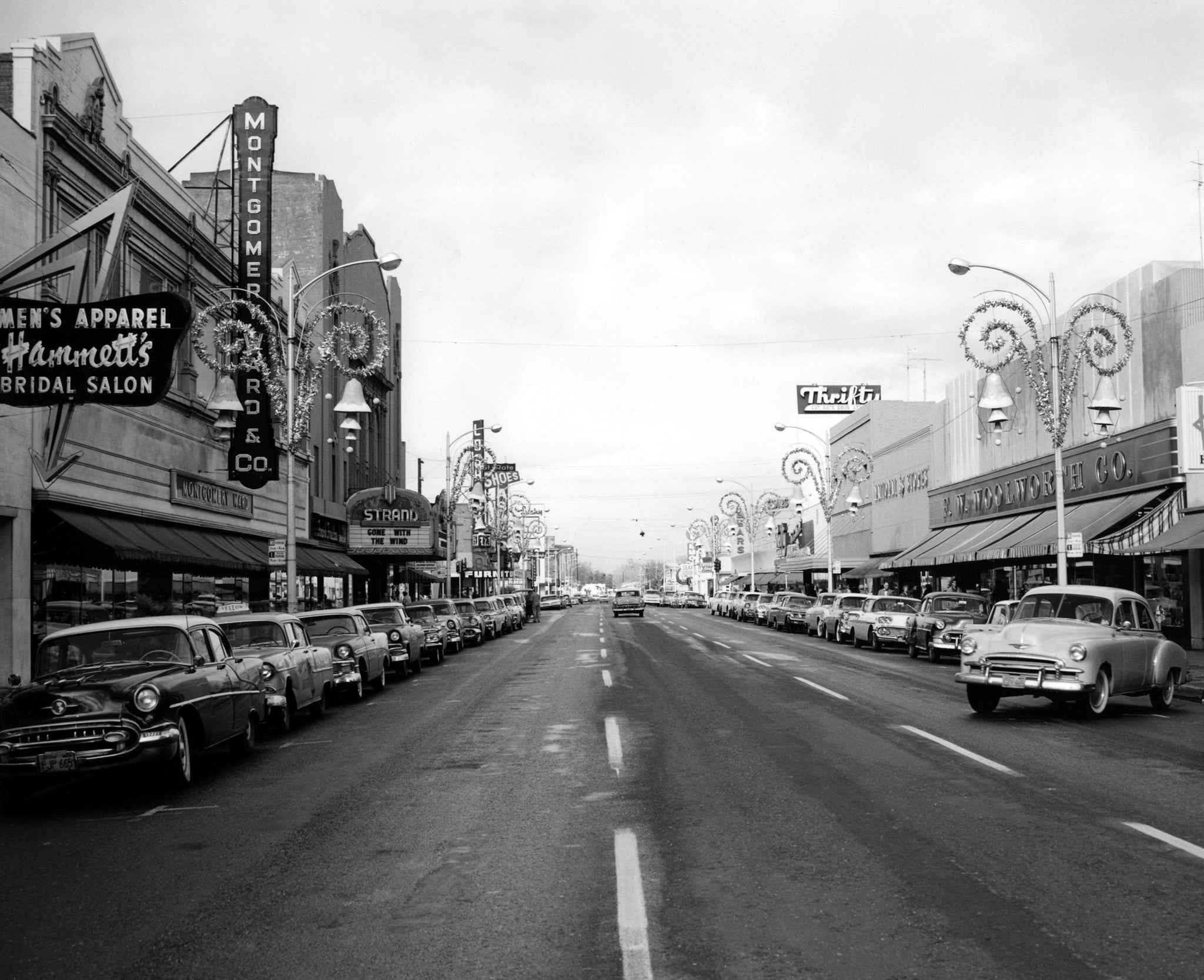 Street view with Christmas decorations, 10th and J Streets looking toward the Strand Theater, Modesto, 1958. -- McHenry Museum