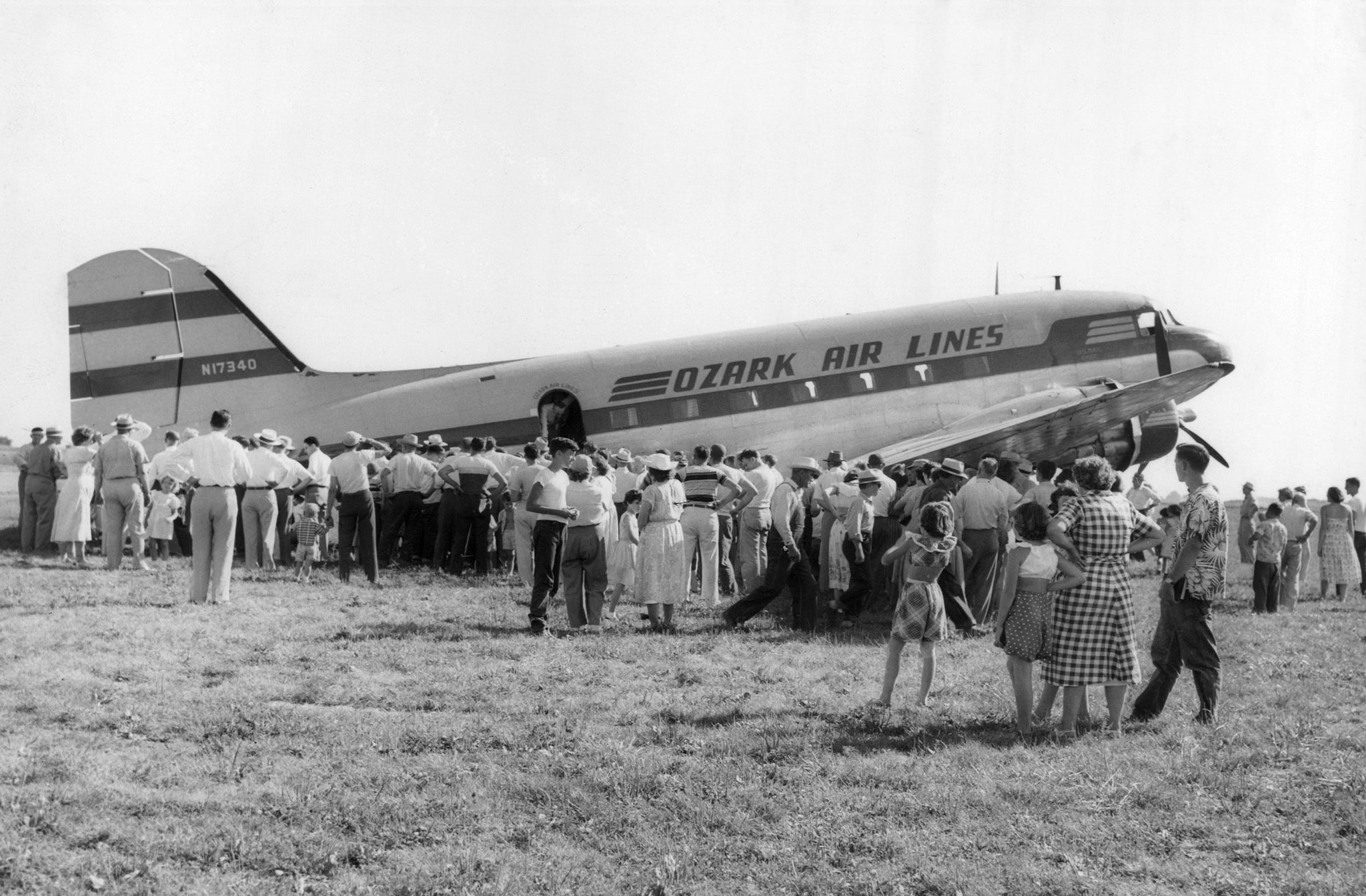 An Ozark DC-3 being inspected by curious citizens on Air Carrier Get Acquainted Day at Municipal Airport, 1951. It was a day where the plane was open to public viewing, and a few lucky citizens took a ride around Bloomington. -- Courtesy of the McLean County Museum of History, Pantagraph Collection 