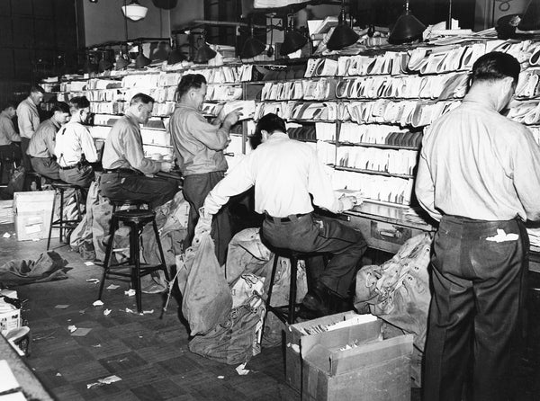 Postal workers sort mail during the Christmas rush at the Davenport Post Office, 1946. -- Philip Serrurier