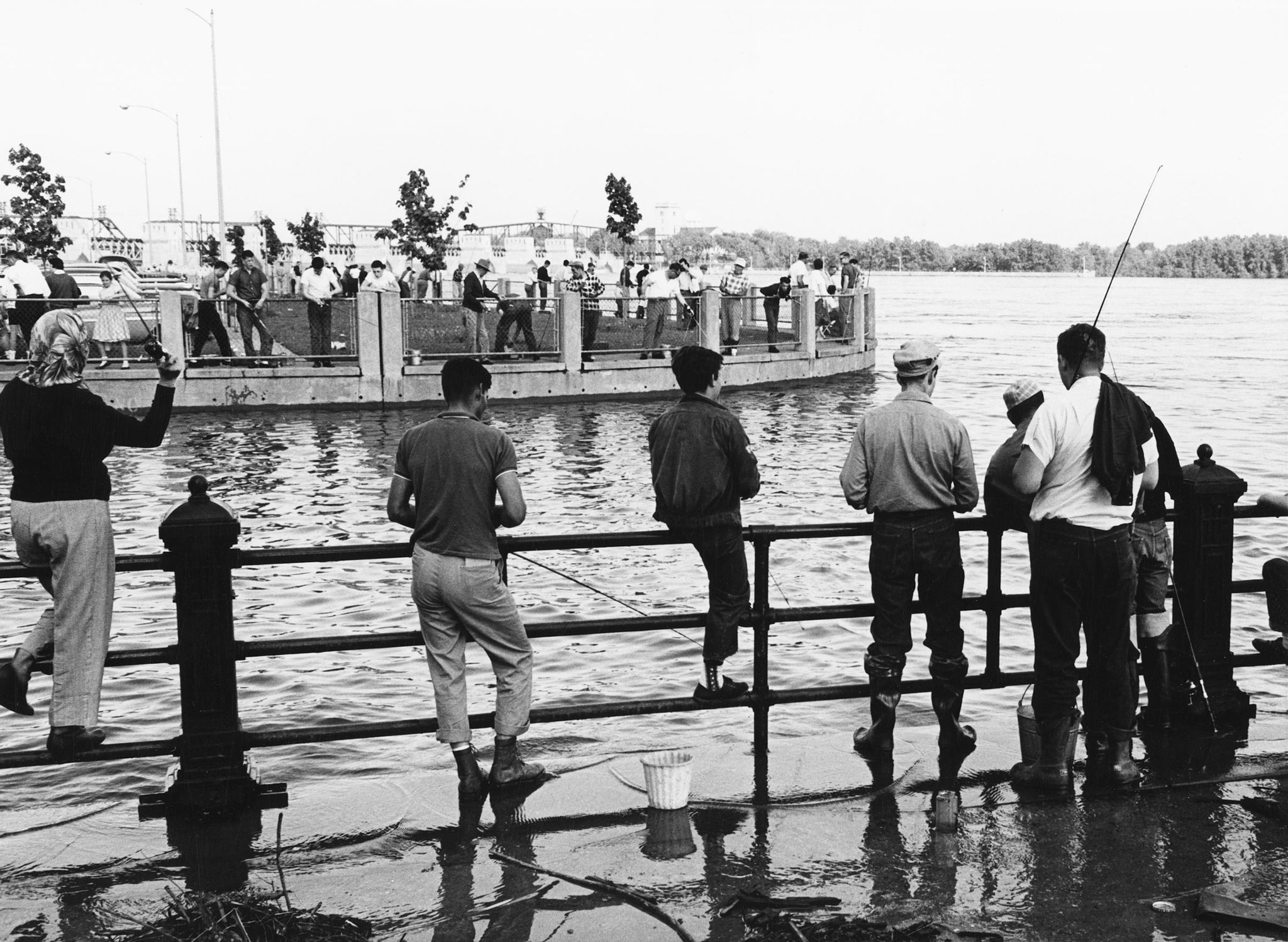 People fishing in the Mississippi River during flooding in Davenport, 1965. -- Quad-City Times