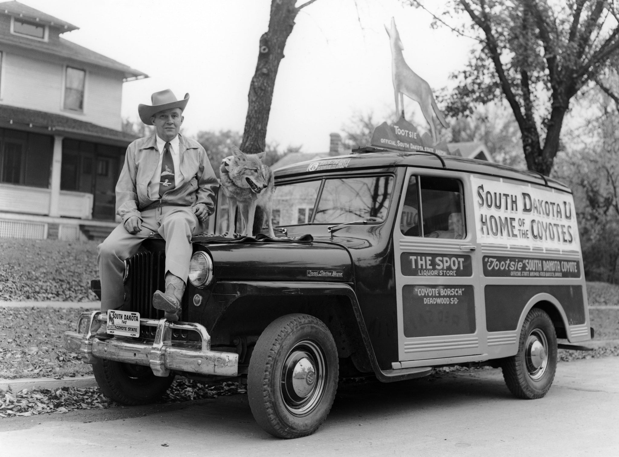 “Coyote” Fred Borsch and Tootsie the Singing Coyote with the Spot Liquor Store wagon, Deadwood, 1953. Tootsie was dubbed South Dakota’s State Animal by Gov. George Mickelson in 1949. -- Courtesy Deadwood History, Inc.