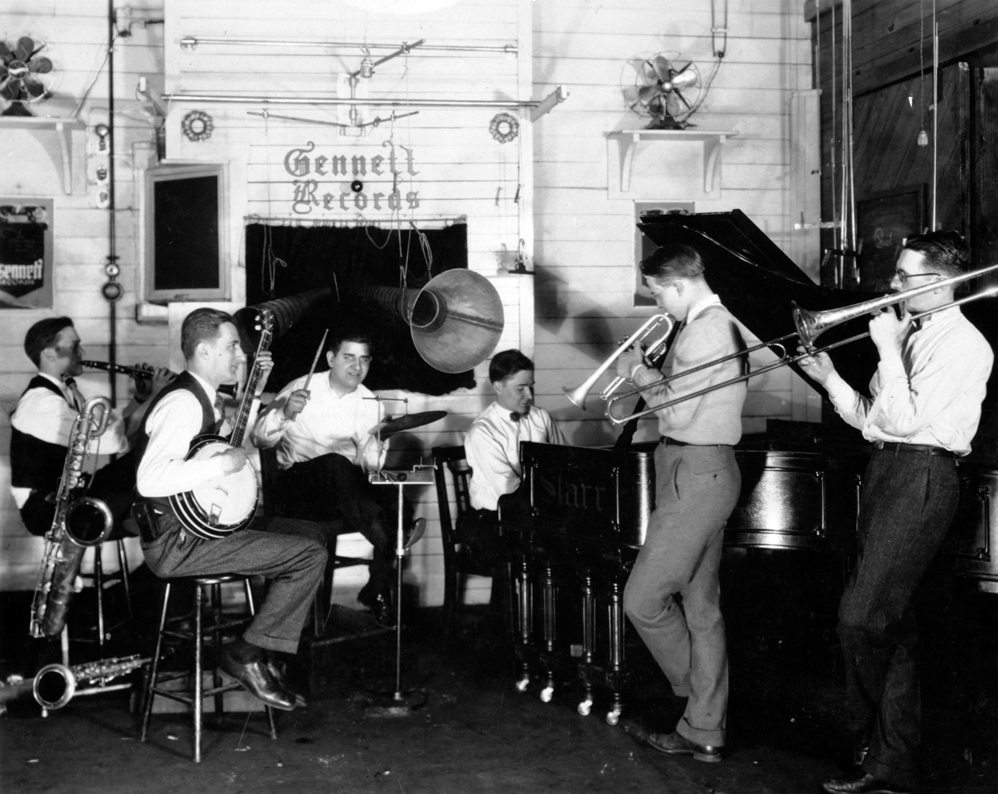 Bix's Rhythm Jugglers at Gennett Recording Studio in Richmond, Indiana, 1925. Band, from left: Don Murray (clarinet), Howdy Quicksell (banjo), Tommy Gargano (drums), Paul Mertz (piano), Bix (cornet), Tommy Dorsey (trombone).  -- The Richardson-Sloane Special Collections Center, Davenport Public Library