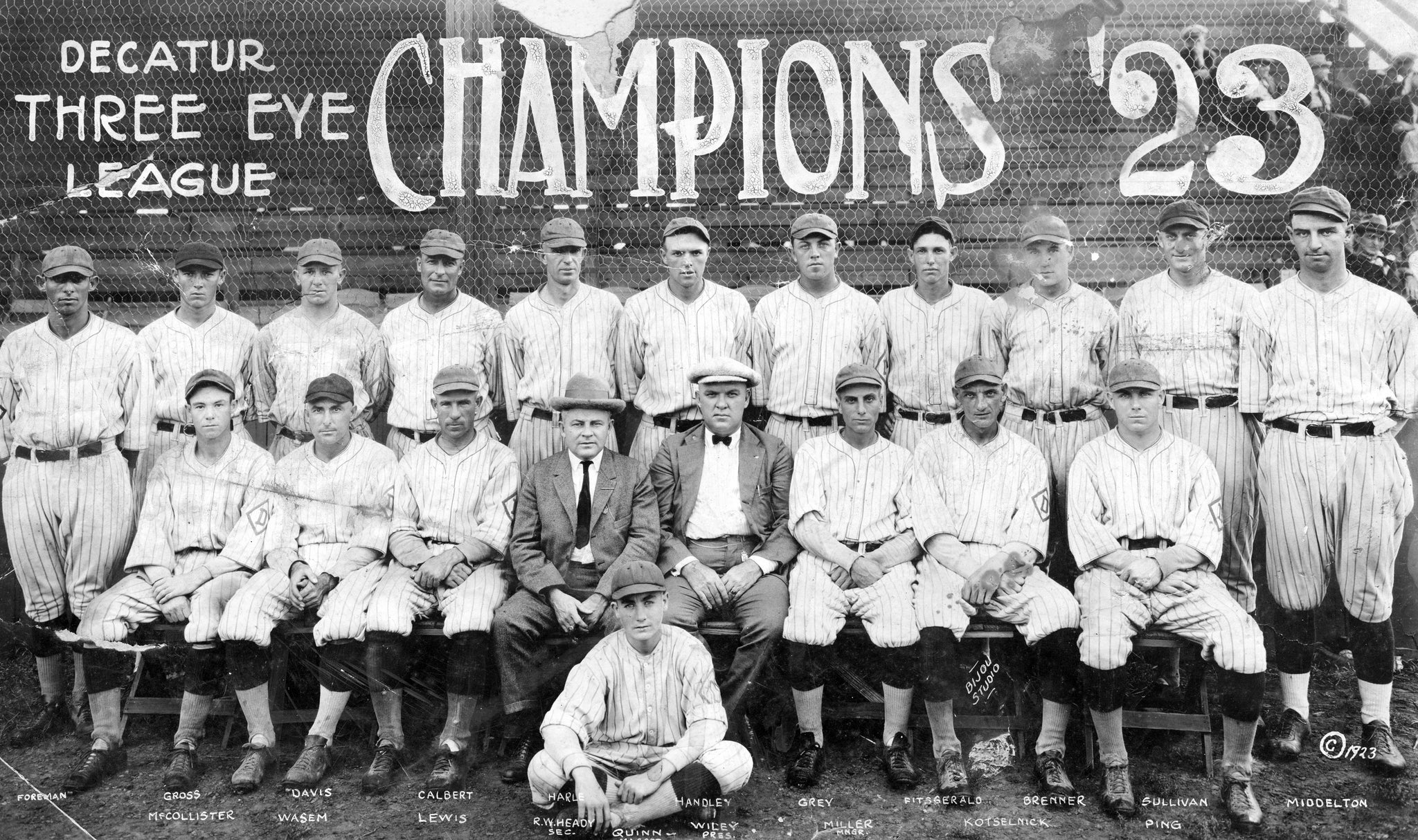 Decatur Commodores, Three-I League Champions of 1923. Front row, from left: Ralph McCollister, Fred Wasem, Lewis, R.W. Heady, Quinn (on ground), Wiley, Chuck Miller, Jack Kotselnick, Don Ping. Back row: Happy Foreman, Dan Gross, Glenn Davis, Ernest Calbert, Glen Harle, Handley, Gray, Fitzgerald, Brenner, Sullivan, John Middleton. -- Decatur Genealogical Society