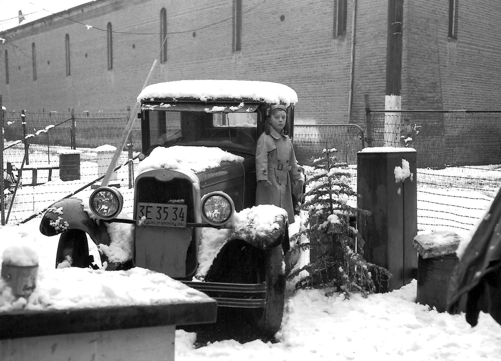 A view of the rear of the old Legion Hall taken from the yard of the Hollingshead Photography Studio at 414 First Street, Woodland, 1936. In the foreground is the 1928 Chevrolet that Paul and Vera Hollingshead drove from New York to California. Paul’s eldest son Edward is on the running board. -- Courtesy Bill and Edward Hollingshead; Photo by Paul W. Hollingshead