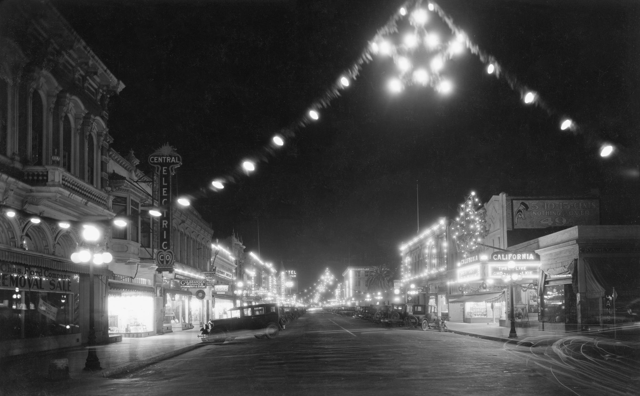 Holiday lighting along Main Street, Watsonville, 1920s. The Central Electric Company is on the left. -- CENTRAL ELECTRIC COMPANY