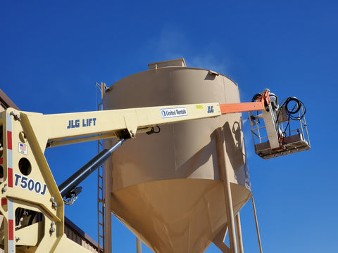 spraying durabak liner onto feed silo