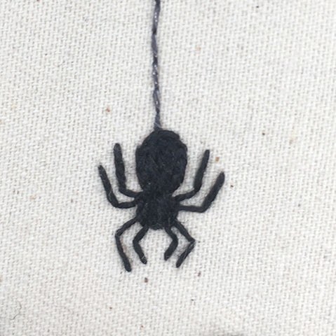 Close up of embroidered spider in halloween embroidery design